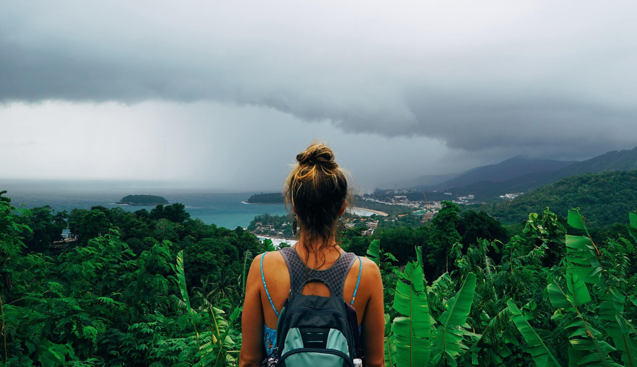 girl back-packer hiker view follow-me looking landscape water sea island volcano clouds tropical real UGC travel content photography